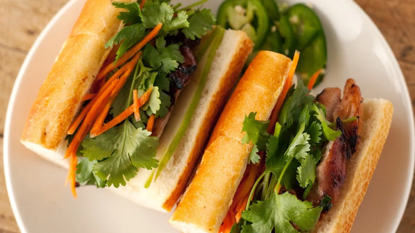 Grilled meat bánh mì with pickled carrots and cilantro